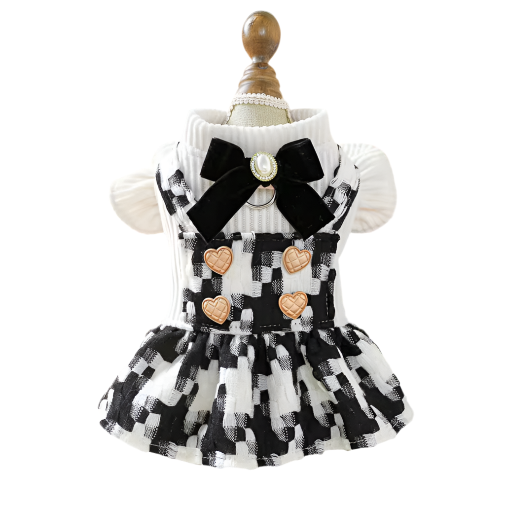 A black and white checkered plaid crochet dress with a bow and heart decorations on a mannequin.