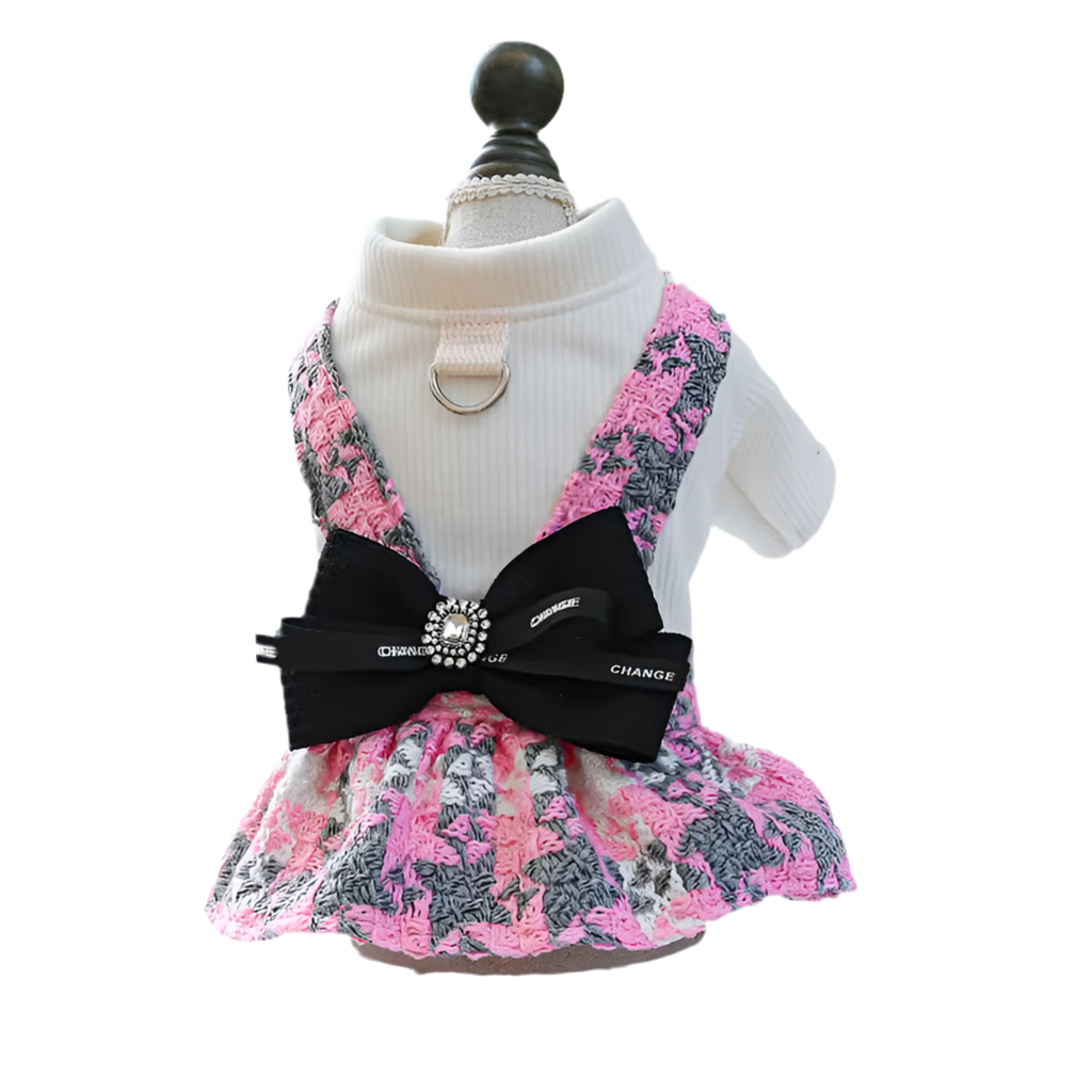 A floral crochet skirt in pink and black colors with a white harness top, displayed on a mannequin.